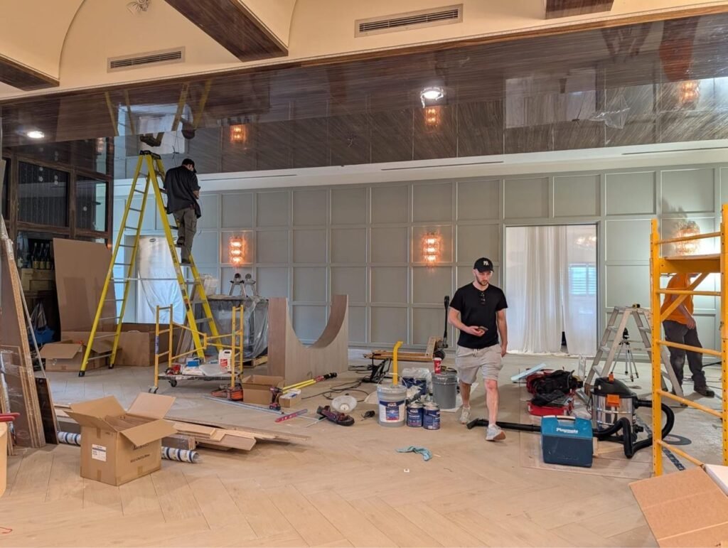 T.H. Cabinets crew installing panelled millwork in a restaurant