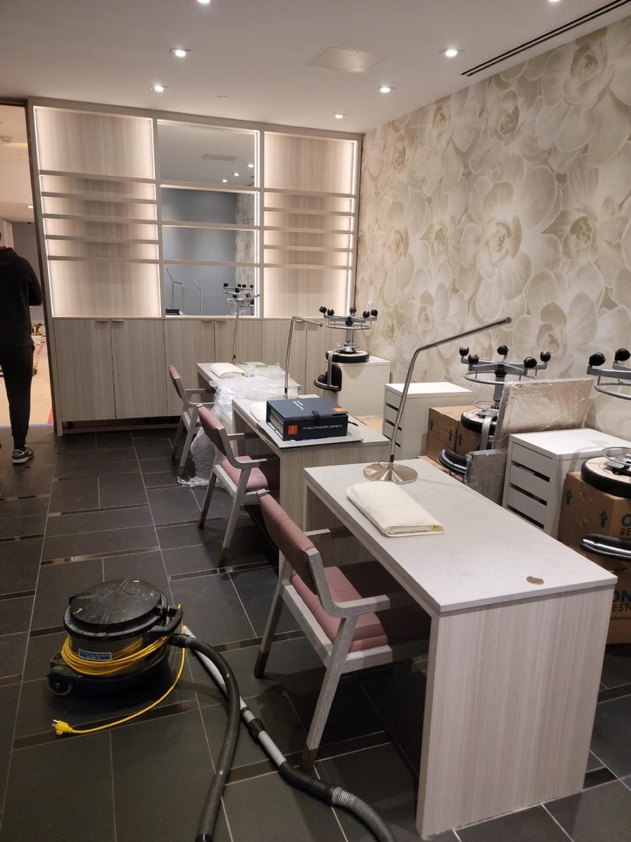 T.H. Cabinets crew fitting out salon stations and backlit shelving