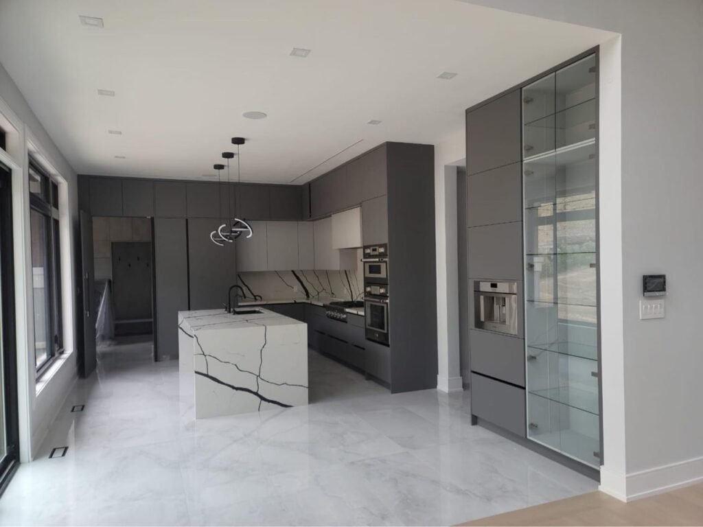 Grey custom kitchen cabinetry and stone waterfall island, T.H. Cabinets project