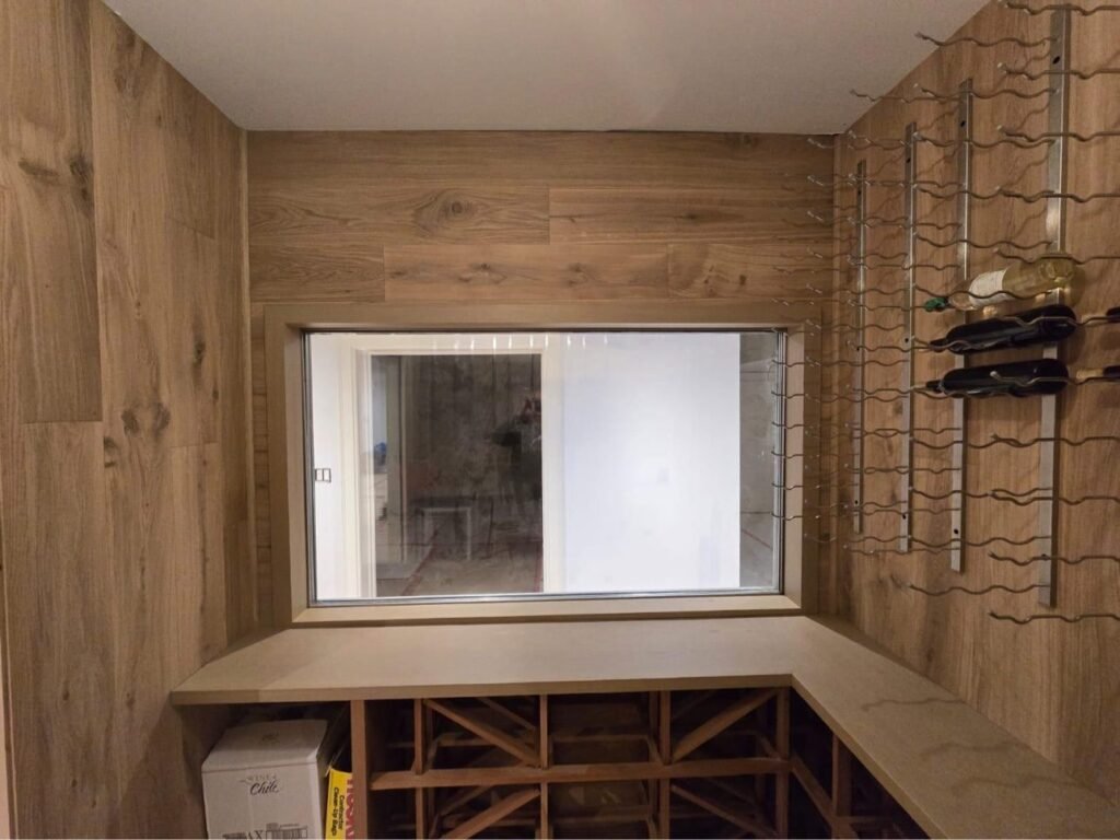 Custom oak wine cellar with wall racking and display storage by T.H. Cabinets