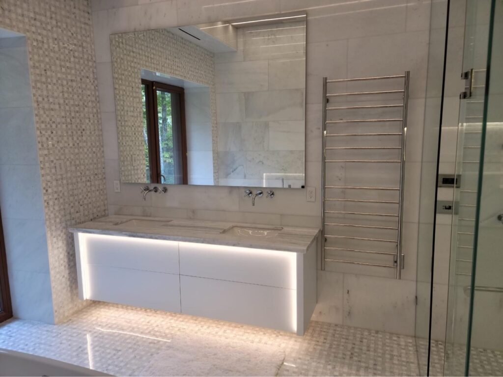 Floating double bathroom vanity with backlit LED cabinetry by T.H. Cabinets