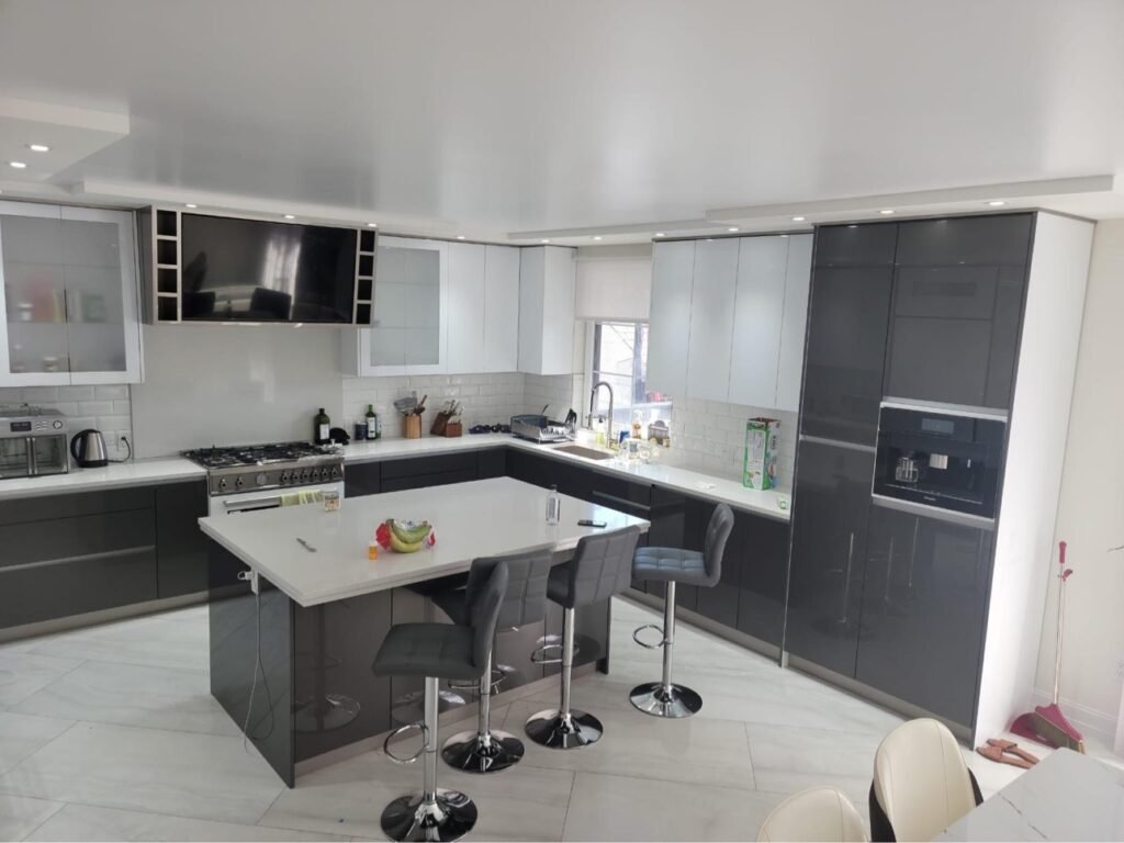 Two-tone grey and white gloss kitchen cabinets by T.H. Cabinets