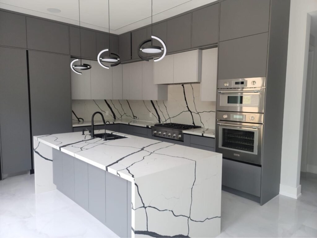 Grey flat-panel custom kitchen cabinets with waterfall island by T.H. Cabinets, Toronto & GTA