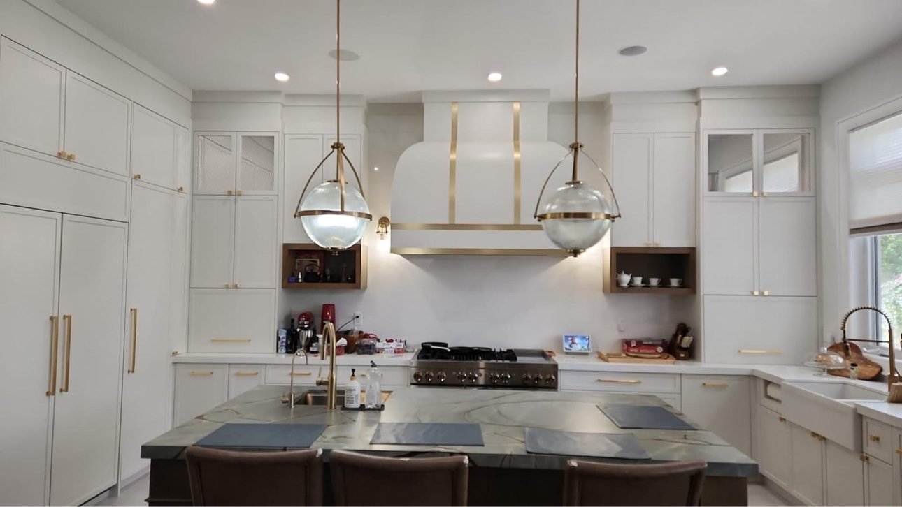 White custom kitchen with brass-accented range hood and full-height cabinetry — a real T.H. Cabinets project, Toronto & GTA