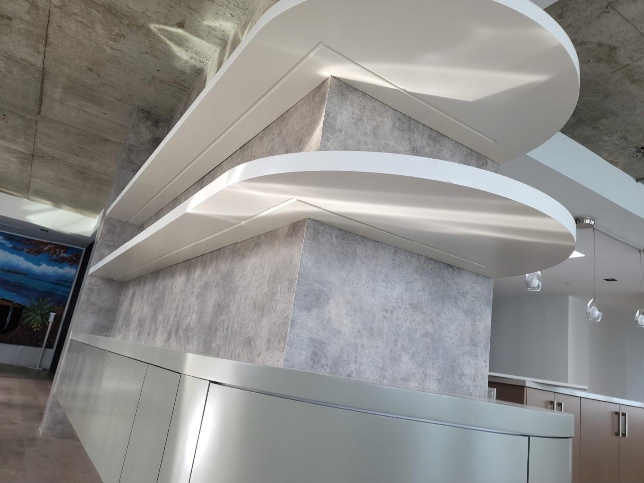 Curved floating shelves and stone feature wall, custom loft millwork by T.H. Cabinets