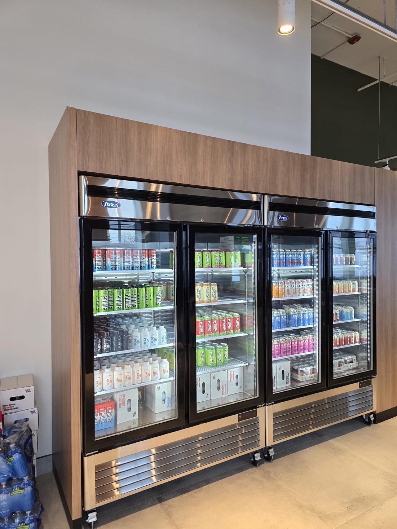 Custom wood refrigeration surround for a retail space by T.H. Cabinets