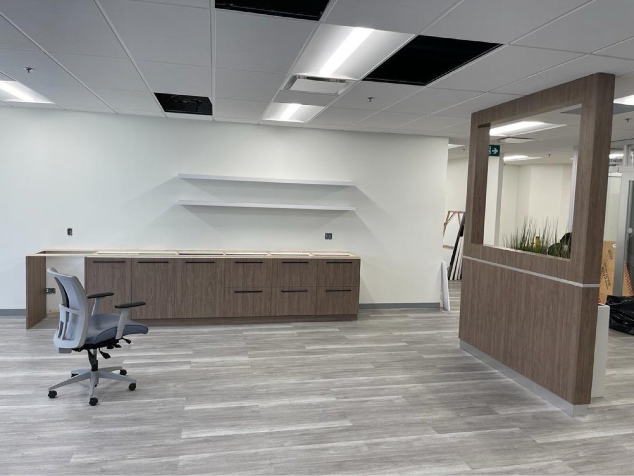 Commercial office with walnut cabinetry and feature partition by T.H. Cabinets