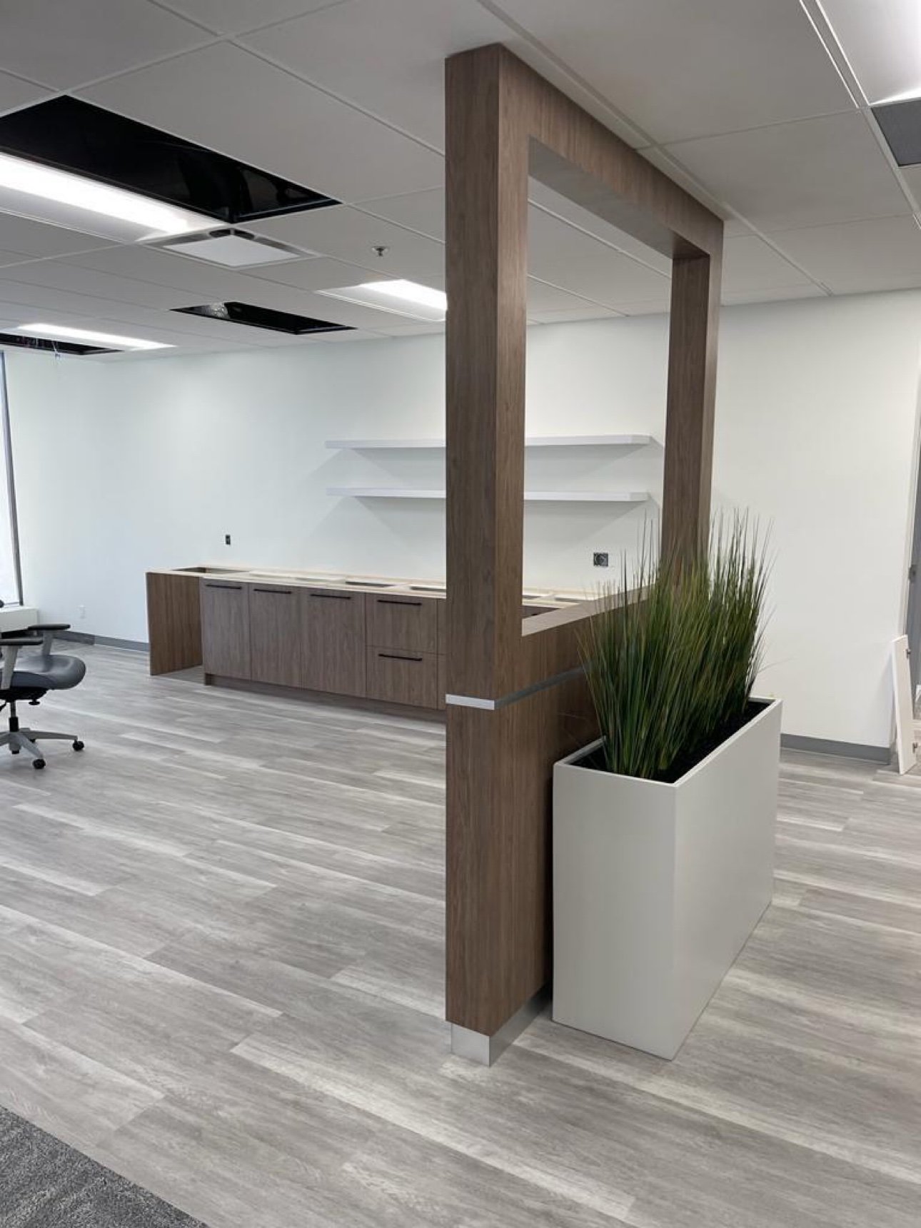 Walnut office millwork with planter partition by T.H. Cabinets